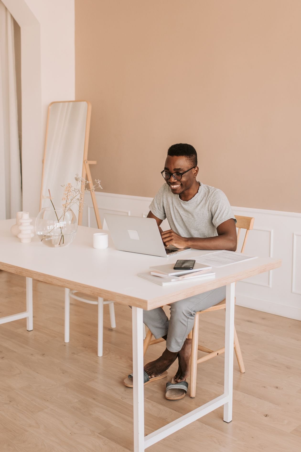 Smiling professional working on a laptop in a bright home office